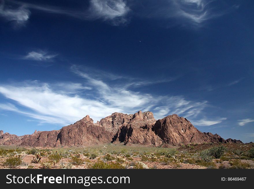 Brown Mountain Under Blue And White Sky During Daytime