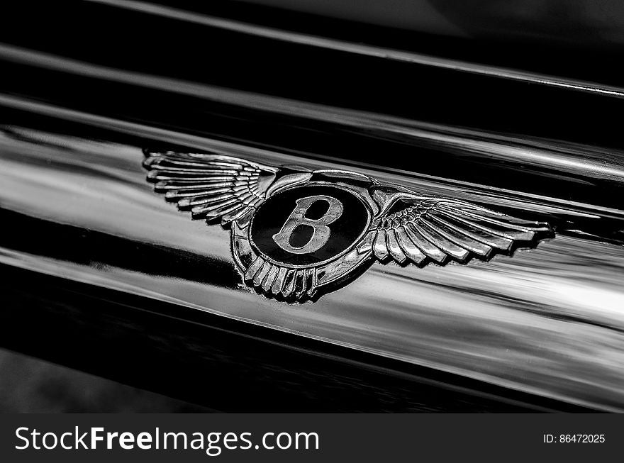 Closeup of Classic Bentley badge on luxury black saloon or sports car. Closeup of Classic Bentley badge on luxury black saloon or sports car.