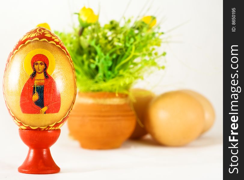 Easter and religion - painted egg and ornaments over white