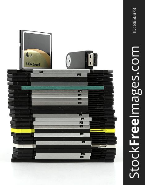 Flash memory devices and pile of floppy disks on white background. Flash memory devices and pile of floppy disks on white background