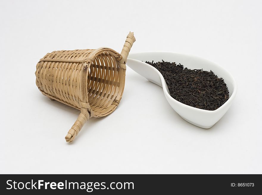 Black tea in cup with bamboo sifter.