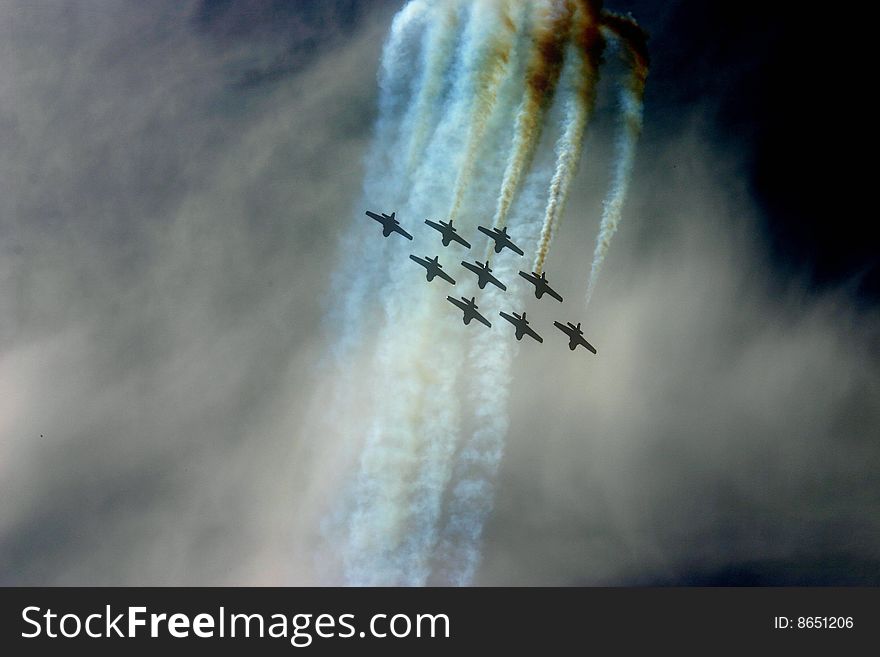 Nine jets in air show performing routine. Nine jets in air show performing routine.