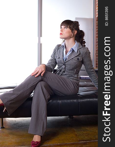 Business woman sitting in a modern office. Business woman sitting in a modern office