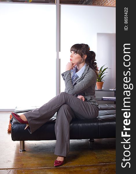 Business woman thinking in a modern office. Business woman thinking in a modern office