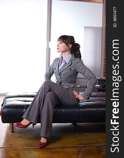 Business woman sitting in a modern office. Business woman sitting in a modern office