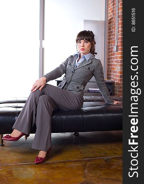 Business woman sitting in a modern office. Business woman sitting in a modern office