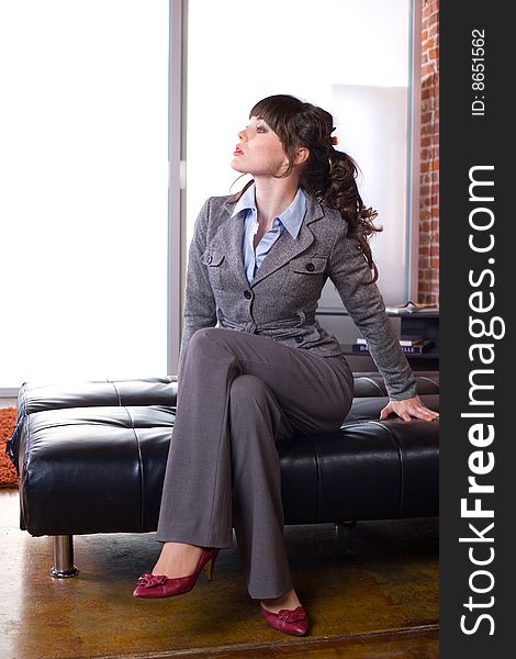 Business woman sitting in a modern office. Business woman sitting in a modern office