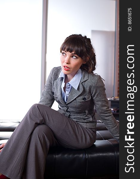 Business woman sitting in a modern office. Business woman sitting in a modern office