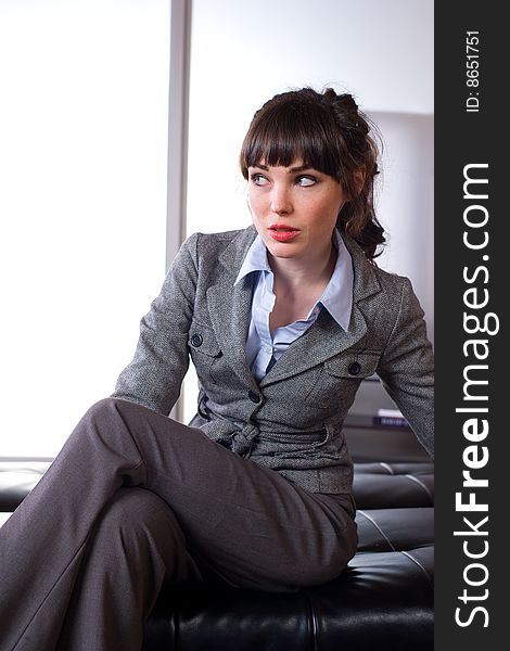 Business woman sitting in a modern office. Business woman sitting in a modern office