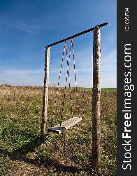 Wooden swing in the field