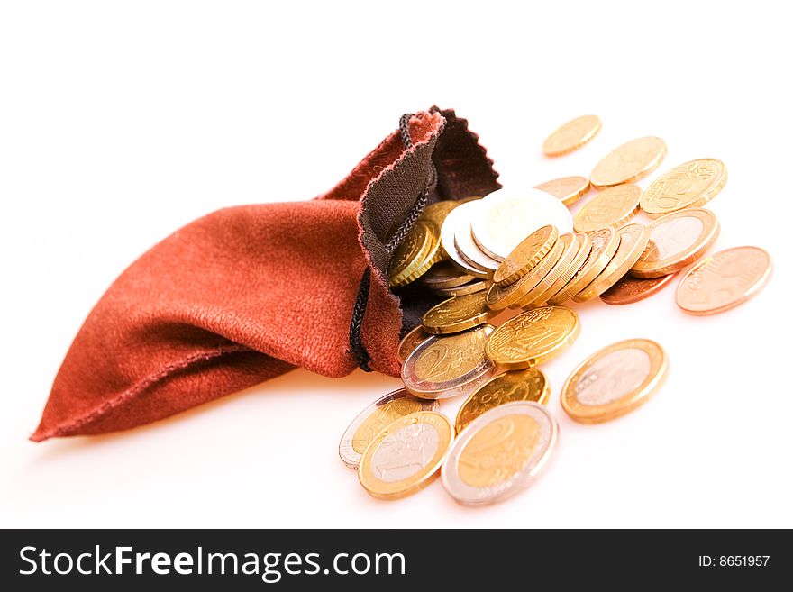 Euro coins and small bag isolated on white. Euro coins and small bag isolated on white.