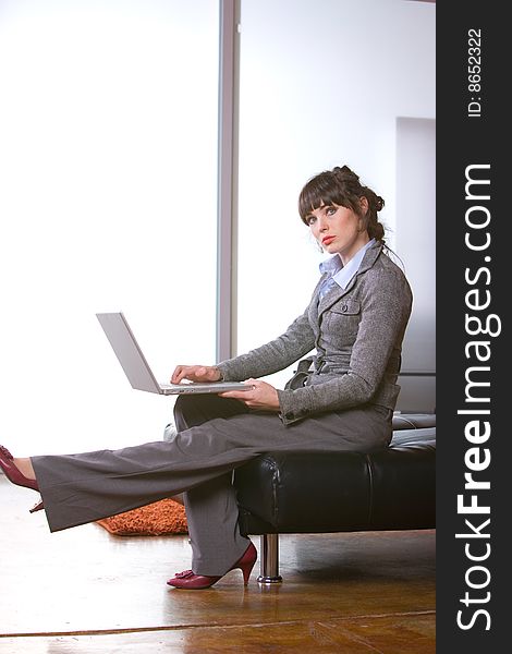 Business woman sitting in a modern office. Business woman sitting in a modern office