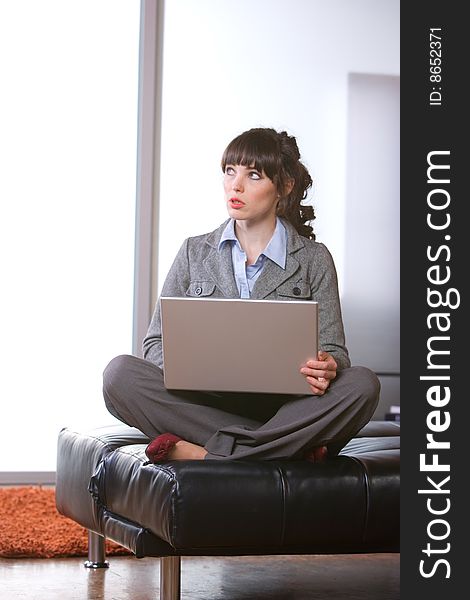 Business woman thinking in modern office with laptop. Business woman thinking in modern office with laptop