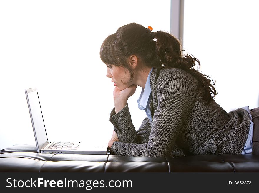 Business Woman on laptop in a modern loft office. Business Woman on laptop in a modern loft office