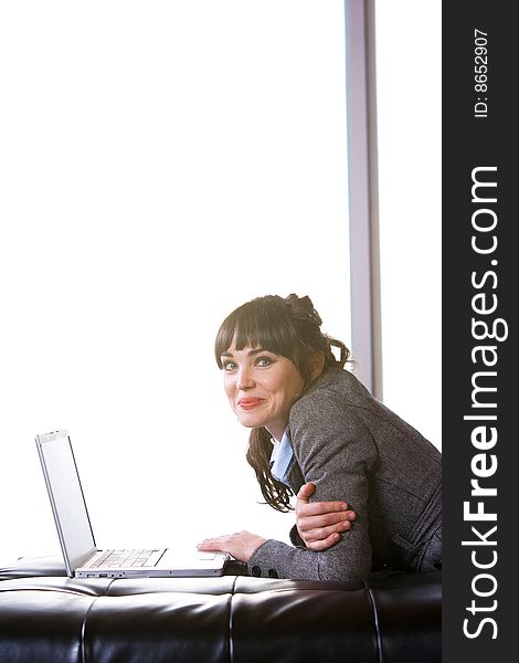 Business Woman on laptop in a modern loft office. Business Woman on laptop in a modern loft office