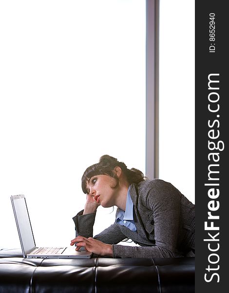 Business Woman on laptop in a modern loft office. Business Woman on laptop in a modern loft office