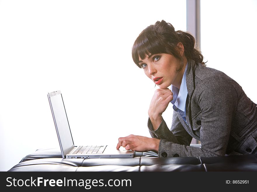 Business Woman on laptop in a modern loft office. Business Woman on laptop in a modern loft office