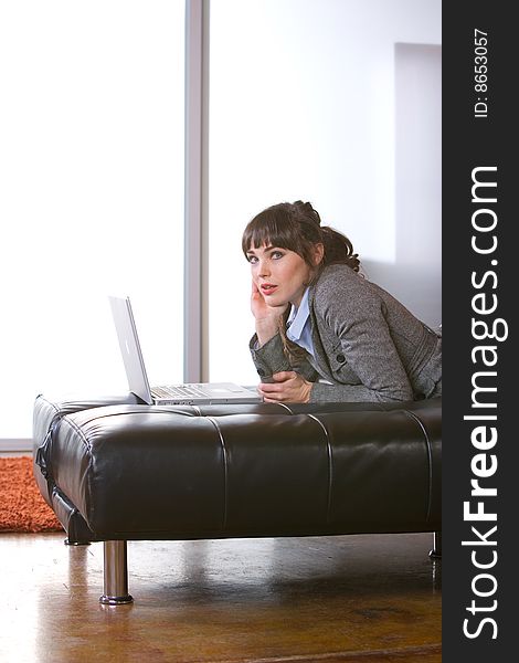 Business Woman on laptop in a modern loft office. Business Woman on laptop in a modern loft office