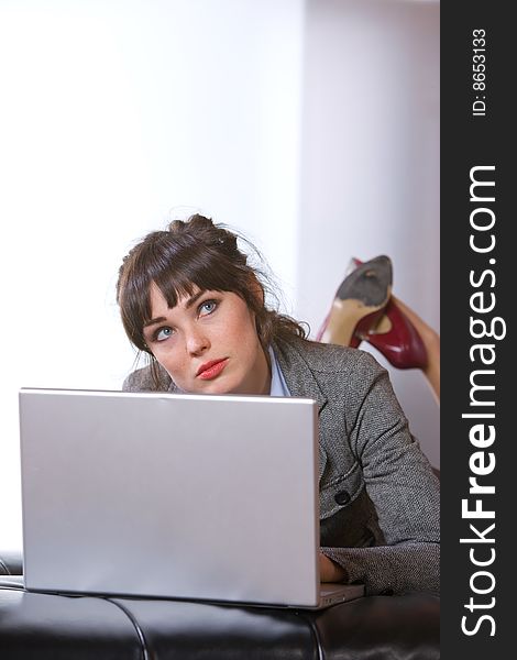 Business Woman on laptop in a modern loft office. Business Woman on laptop in a modern loft office