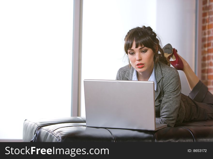 Business Woman on laptop in a modern loft office. Business Woman on laptop in a modern loft office