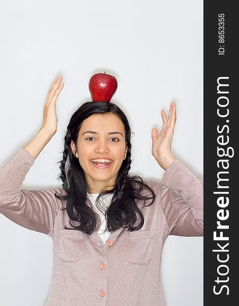 Portrait of smiling young woman holding apple, isolated on white background