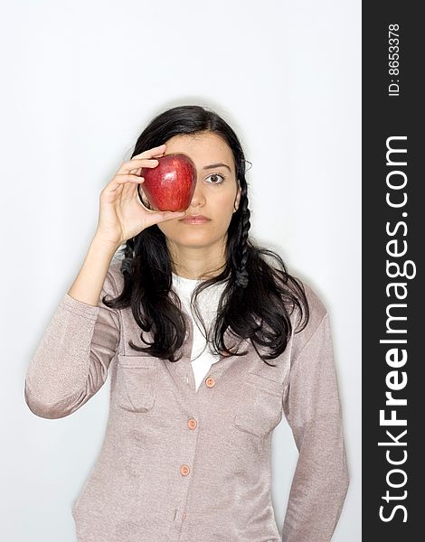 Portrait of smiling young woman holding apple, isolated on white background