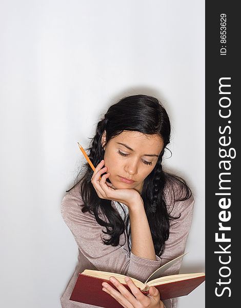 Young woman reading book, isolated on white