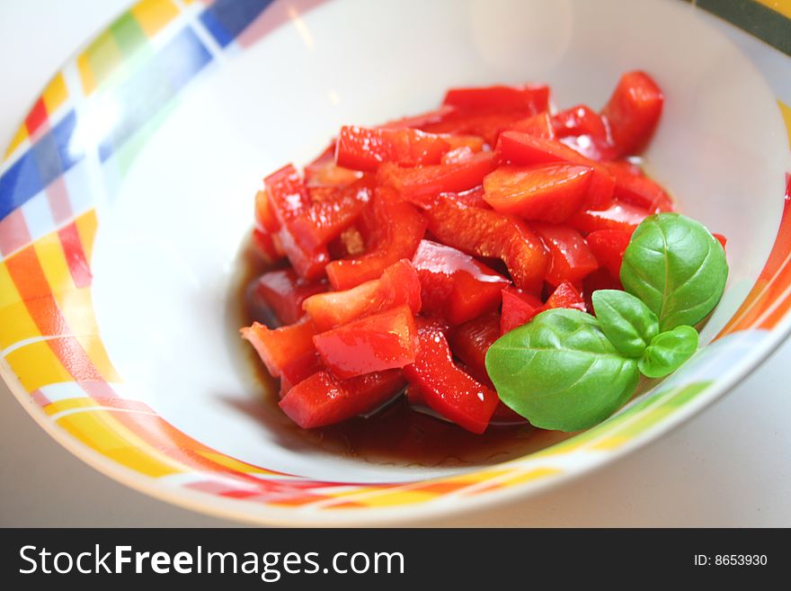 A fresh salad of red paprika with basil