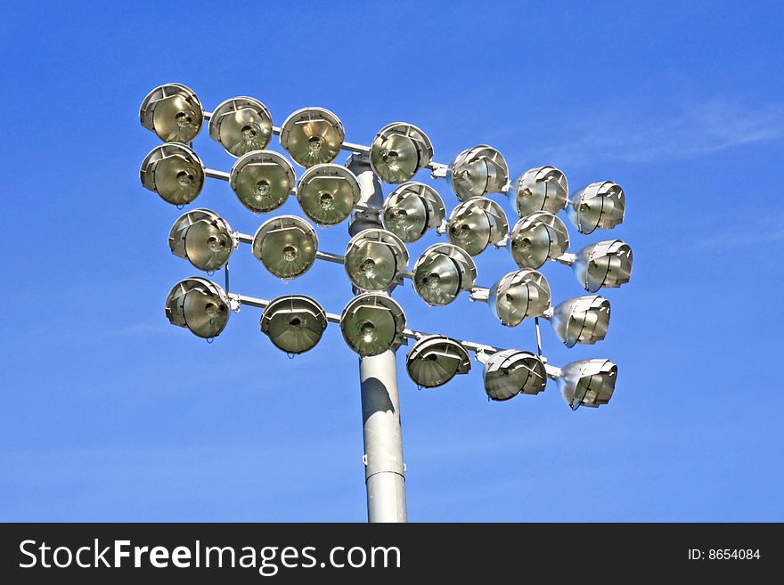 Large array of stadium lights on a bright day.