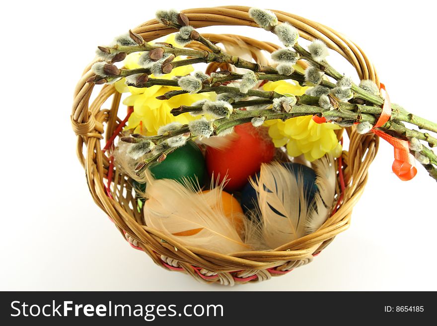 Easter basket, with colored eggs, over white background