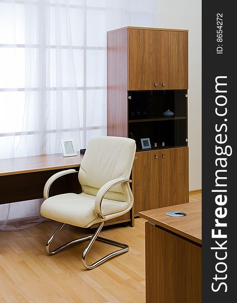 Table, chairs and bookcase at modern office