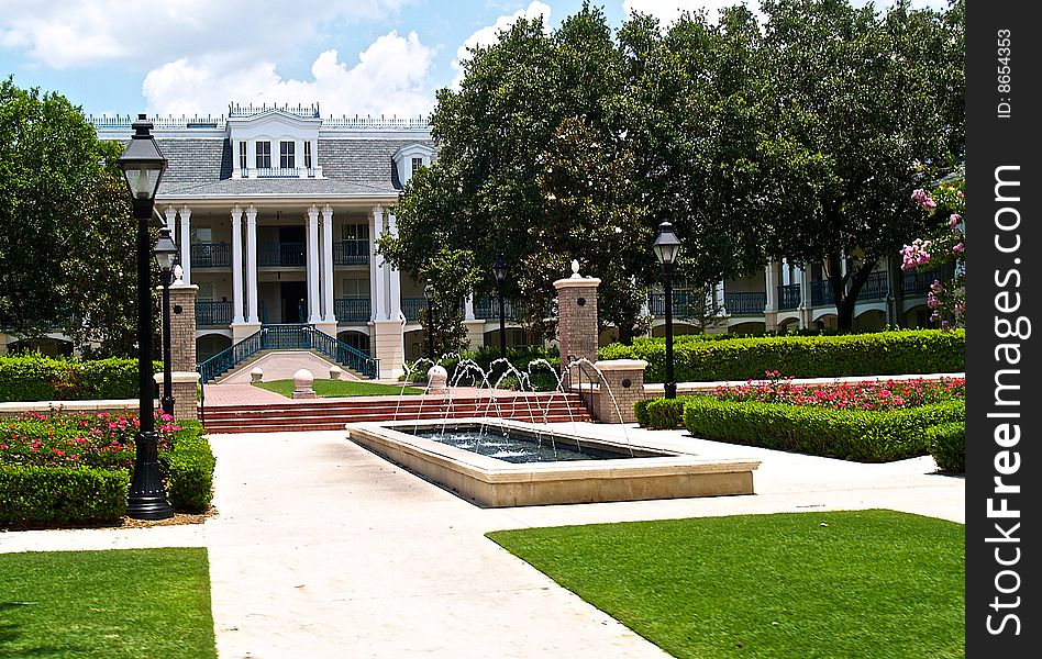 A southern style mansion with a fountain and a lush garden. A southern style mansion with a fountain and a lush garden