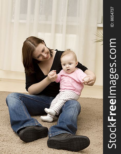 Mother And Baby Playing In Home