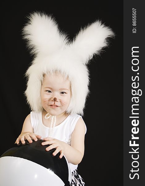 Little girl in a white downy bunny costume.