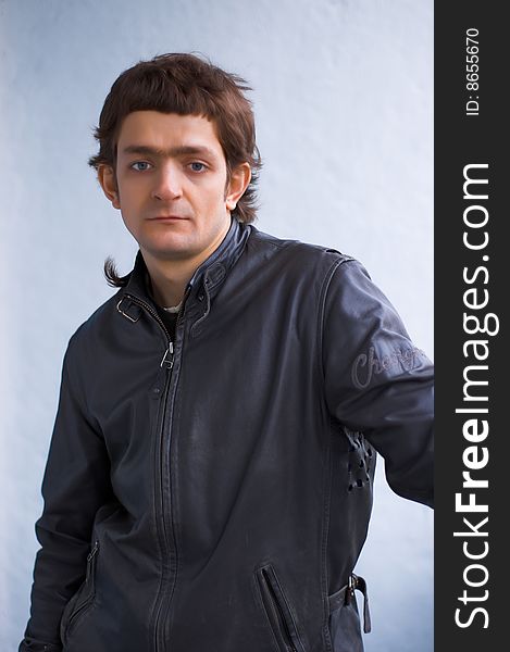 The young reflected person in a black leather jacket. The young reflected person in a black leather jacket.