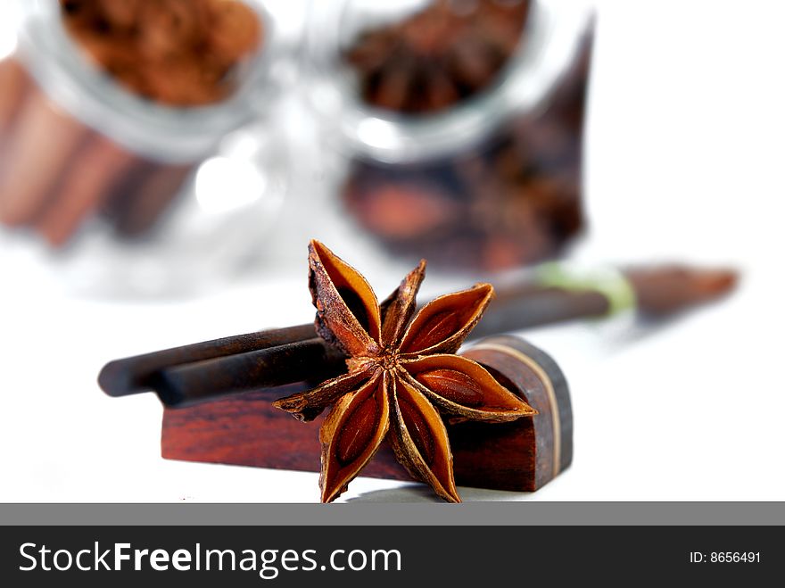 Close up anise star and wooded made chopstick in white background