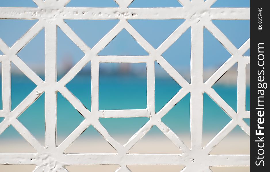 White grating against blue sea and sky