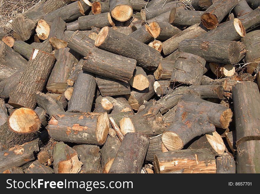 Cut wood in chaotic heap outdoor background. Cut wood in chaotic heap outdoor background