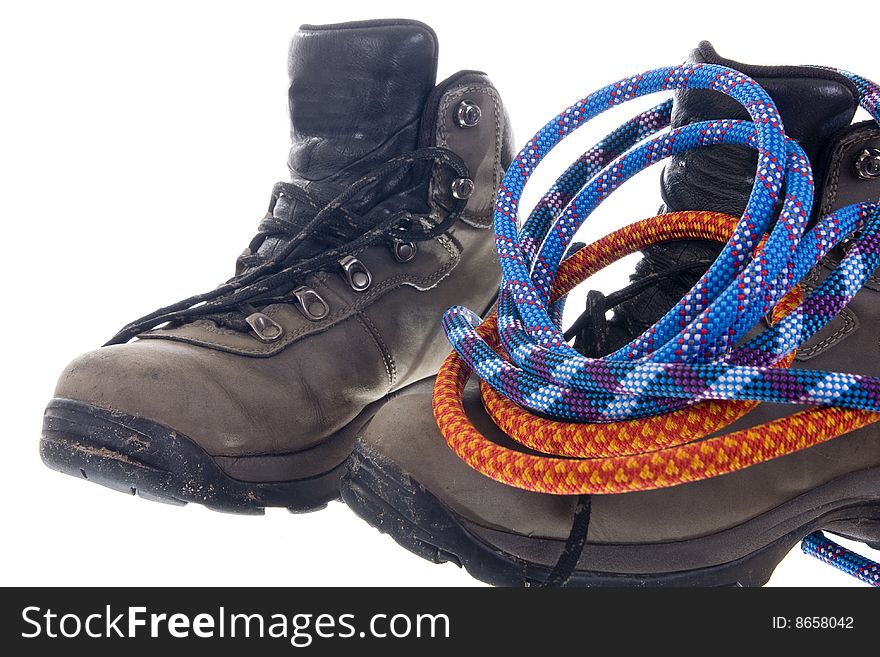 Pair of hiking boots and ropes on white background. Pair of hiking boots and ropes on white background