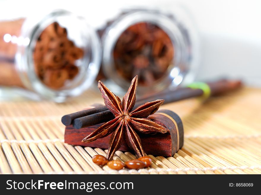 Close up anise star and wooded made chopstick in white background