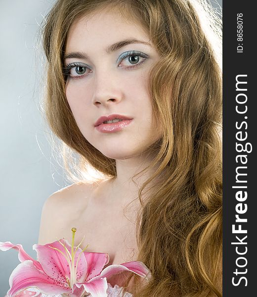 Beautiful young girl with lily flower