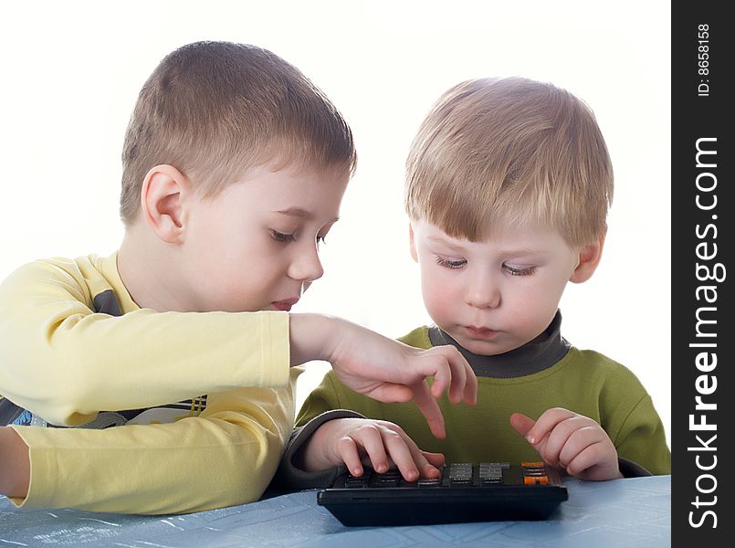 Two children of the boy play with the calculator. Two children of the boy play with the calculator