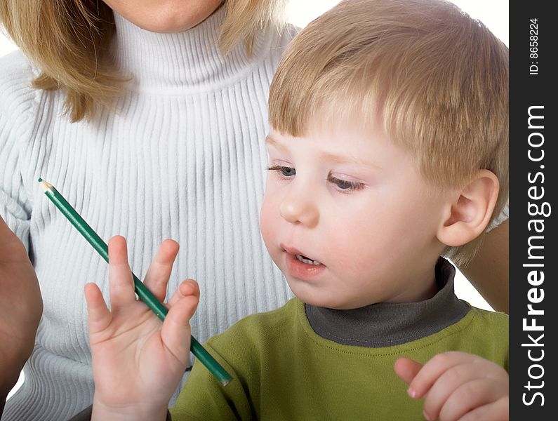 The little boy draws pencils with mum. The little boy draws pencils with mum