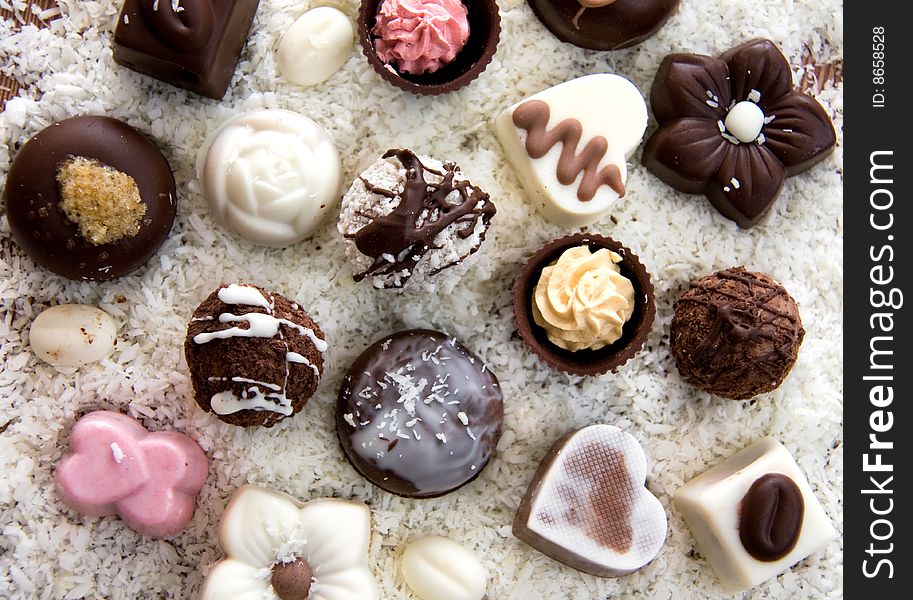 Various Chocolate Candies in Coconut Chips