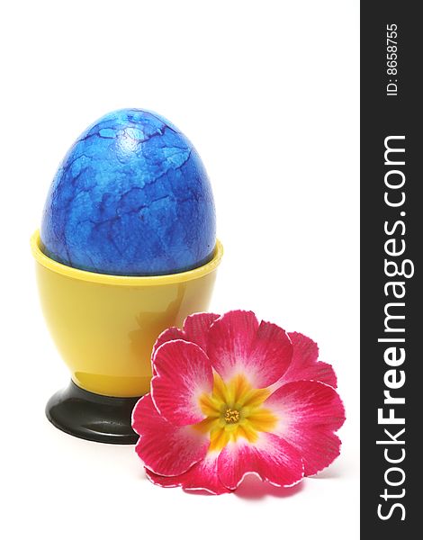 Blue easter egg with red flower on white background.