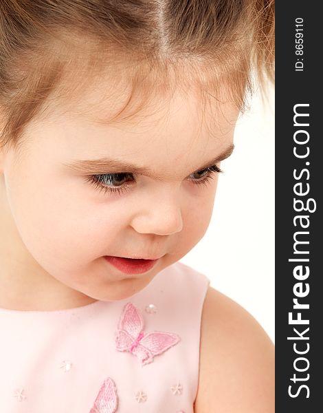 Closeup portrait of a small girl in pink dress. Closeup portrait of a small girl in pink dress