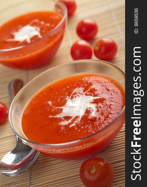 Red tomato soup over bamboo mat