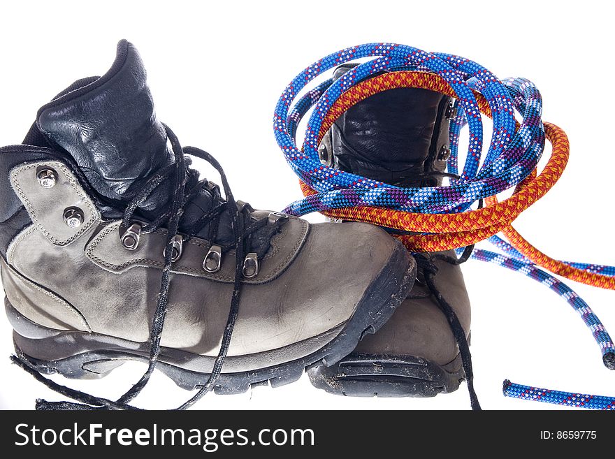 Pair of hiking boots and ropes on white background. Pair of hiking boots and ropes on white background