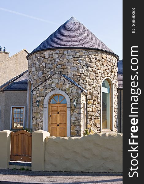 Old school house and gate against blue sky