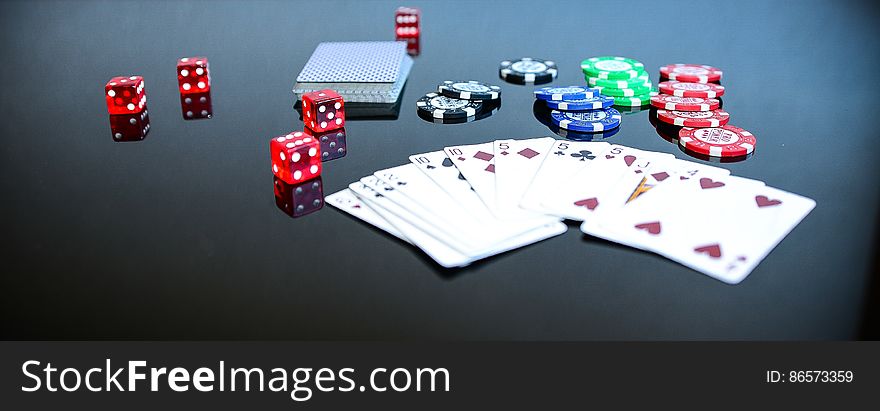 Playing Cards Beside Poker Chips and Dice